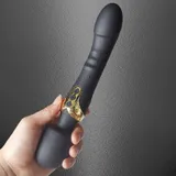Black Dual Head Vibrator held with the curved end pointing upward and the three-button panel facing the camera