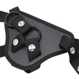 Close-up of the harness front panel with attachment rings, woven straps and an open press-stud fastener