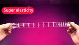 Supplier demonstration of a clear textured Wolf Tooth Braces sleeve stretched lengthwise between two hands, without numeric measurements