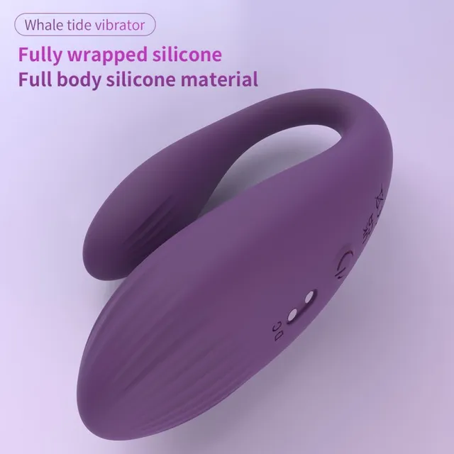 Purple Whale tide vibrator with a curved two-arm body, ridged surface, power button and two charging contacts